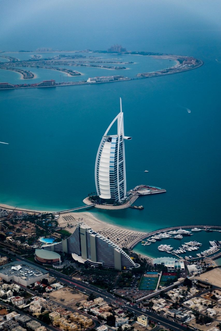The Burj Al Arab, known as the world's most luxurious hotel, offers private butlers, chauffeur-driven Rolls-Royce, and gold-plated iPads in its suites. The Atlantis, The Palm, is a popular resort that features a waterpark, aquarium, and marine animal encounters.