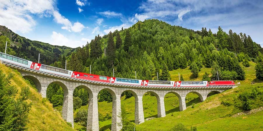 The journey takes about 8 hours and passes through 91 tunnels, 291 bridges, and the famous Oberalp Pass, which reaches an altitude of 2,033 meters.