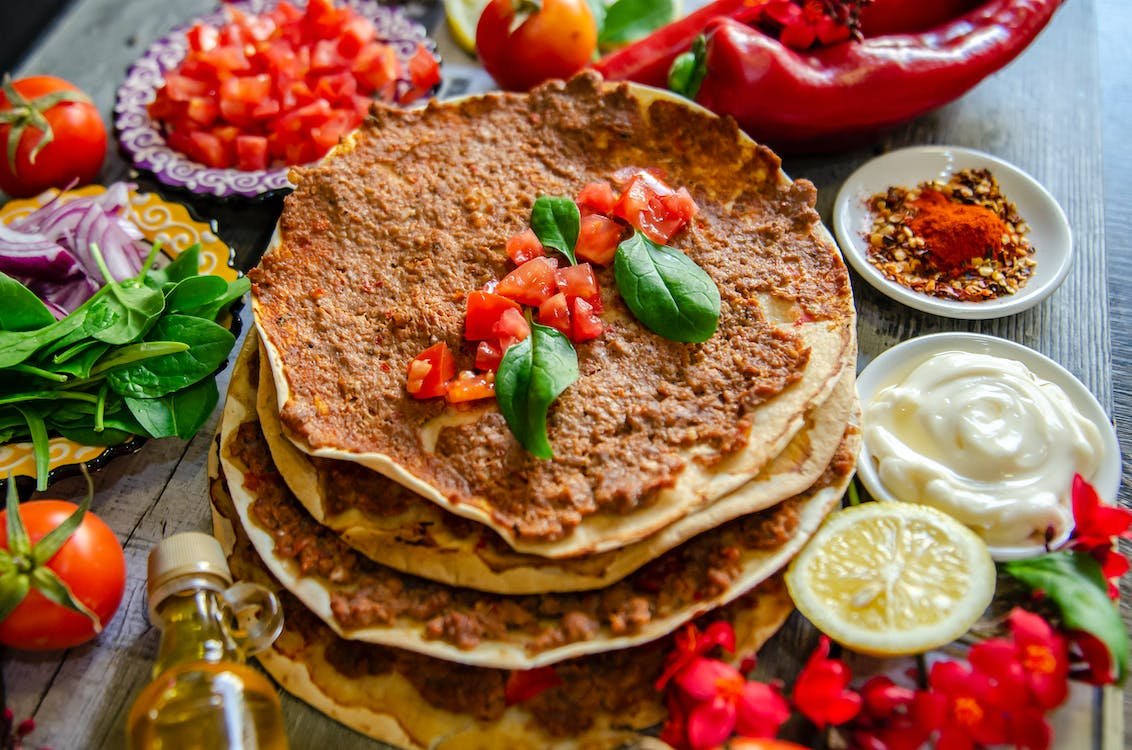 It's usually served with a side of fresh herbs and lemon juice, which you can use to add some extra flavor to the dish. You can find Lahmacun in most street food stalls and bakeries, and the average price is around €2-€3.